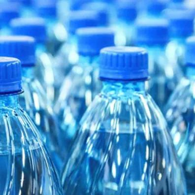 Rows of blue-capped PET water bottles