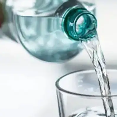 Water poured from a PET bottle into a glass